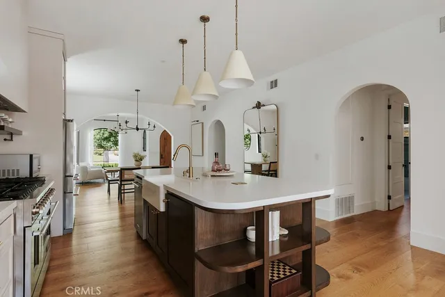 a bathroom with a toilet a sink a mirror a vanity and window