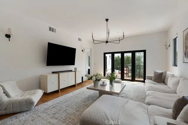 a bedroom with a bed and a large mirror