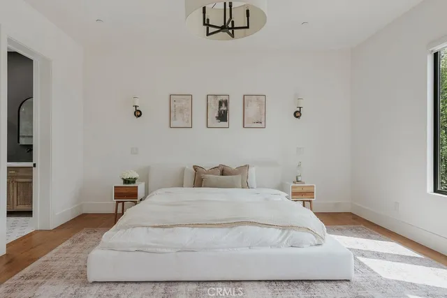 a patio with table and chairs and potted plants