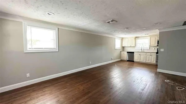 a view of kitchen with stove and wooden floor