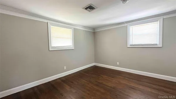 a view of a room with wooden floor and windows