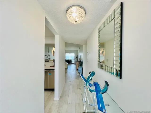 a view of an entryway with wooden floor