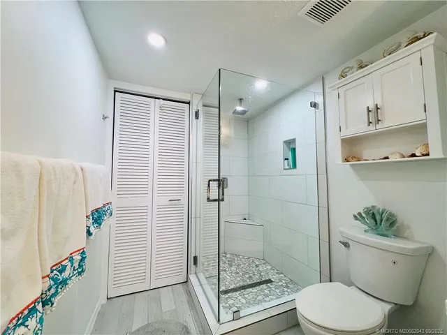 a bathroom with a shower toilet and a sink