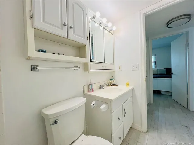 a bathroom with a toilet sink and mirror