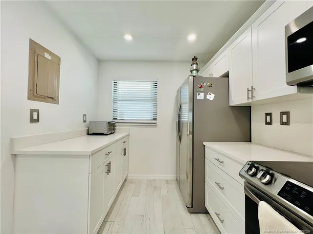 a kitchen with stainless steel appliances a sink stove and refrigerator
