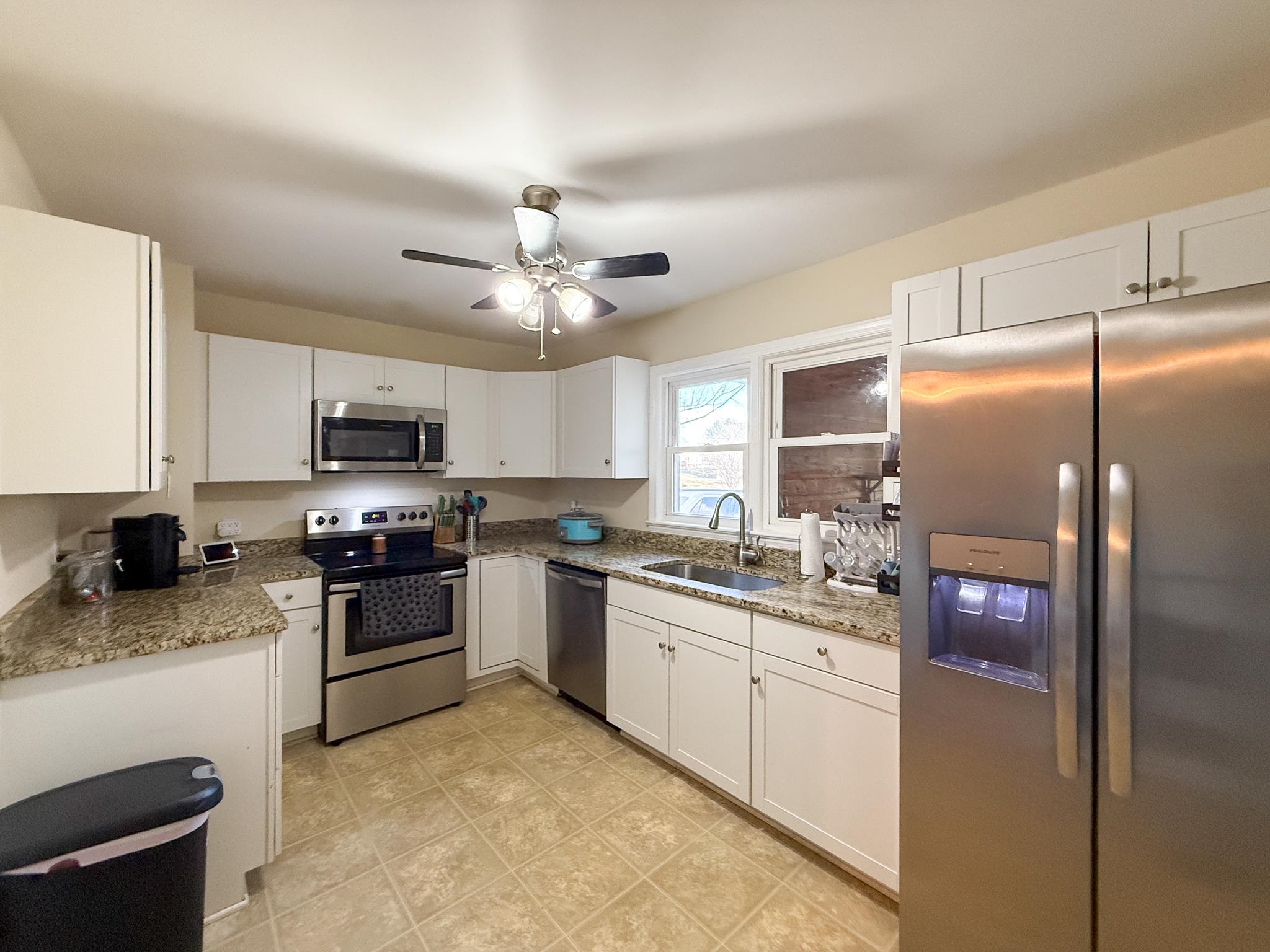 939 Old White Hill Road Stuarts Draft, VA 24477 - Photo 4 of 22 a kitchen with stainless steel appliances granite countertop a stove refrigerator sink and microwave