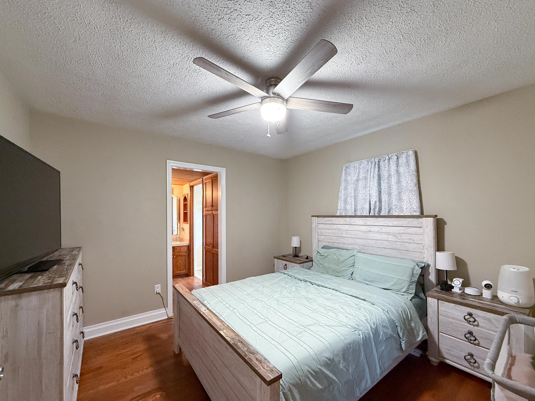 939 Old White Hill Road Stuarts Draft, VA 24477 - Photo 8 of 22 a bedroom with a bed and a flat screen tv