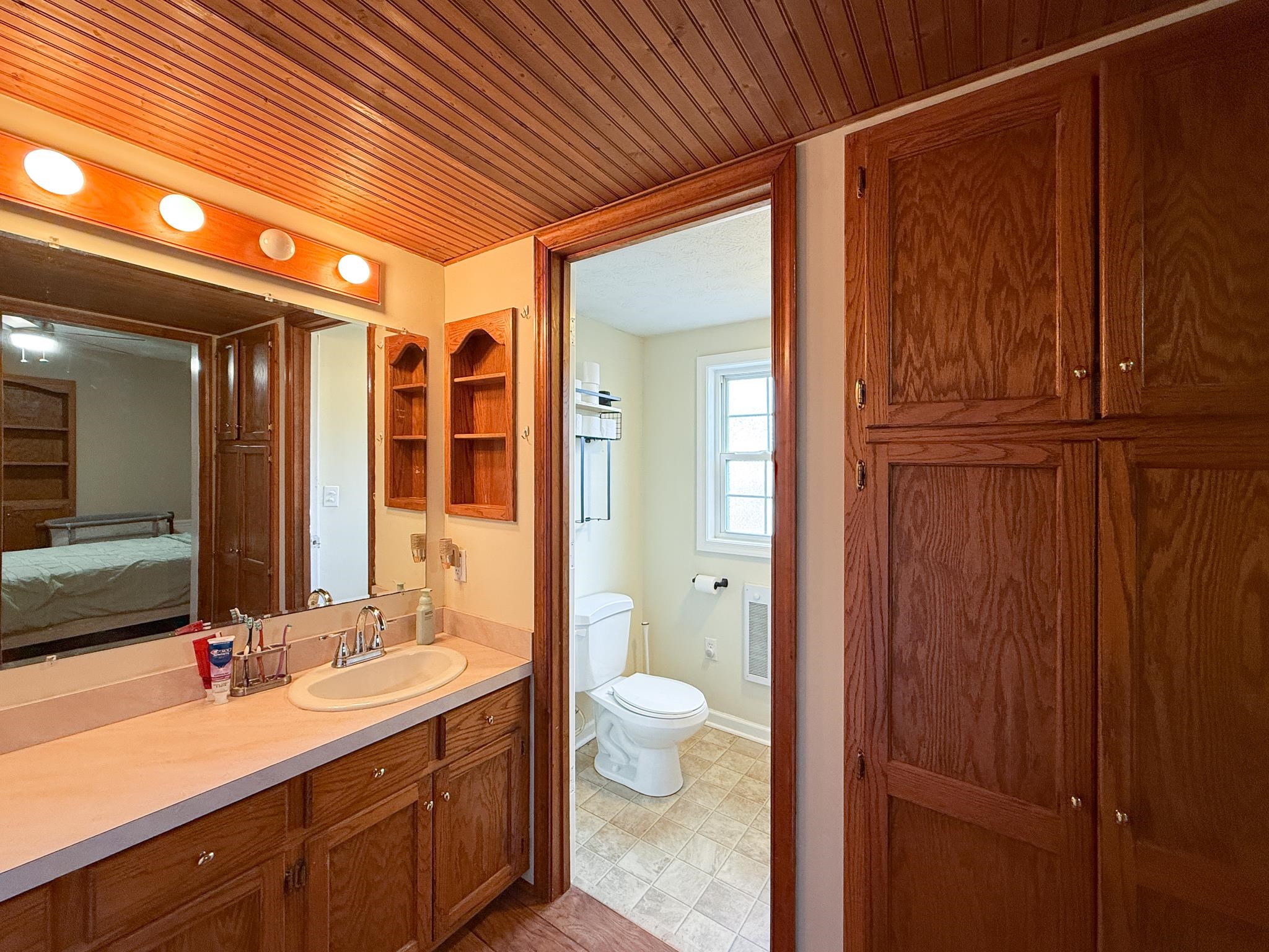 939 Old White Hill Road Stuarts Draft, VA 24477 - Photo 9 of 22 a bathroom with a double vanity sink and a mirror