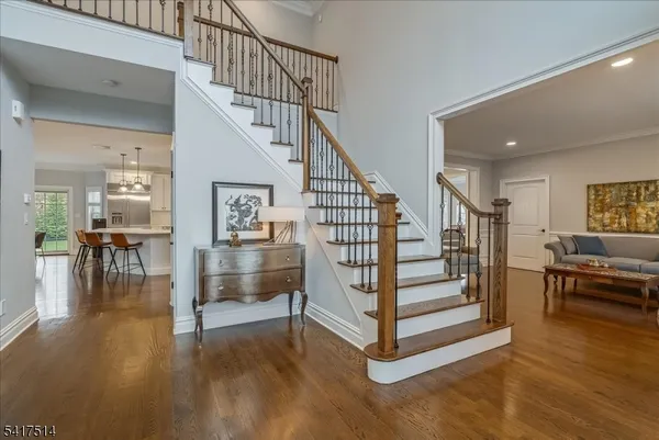 a living room with furniture a table and wooden floor