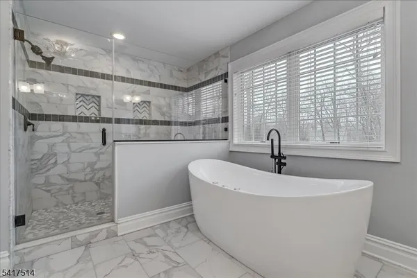 a living room with furniture and a book shelf