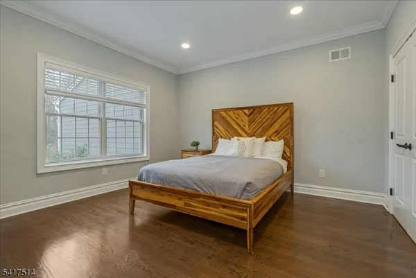 a view of a hallway with wooden floor and entryway