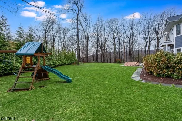 a view of a house with swimming pool and sitting area