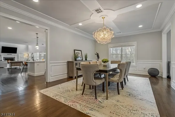 a view of a dining room with furniture and chandelier