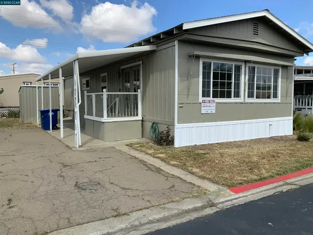 a view of a house with wooden fence