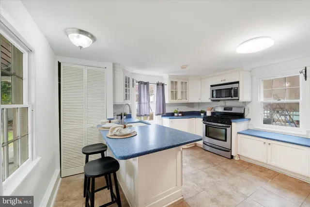 a kitchen with sink cabinets and dining table
