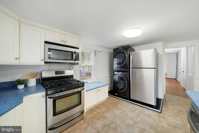 a kitchen with stainless steel appliances a refrigerator stove and microwave