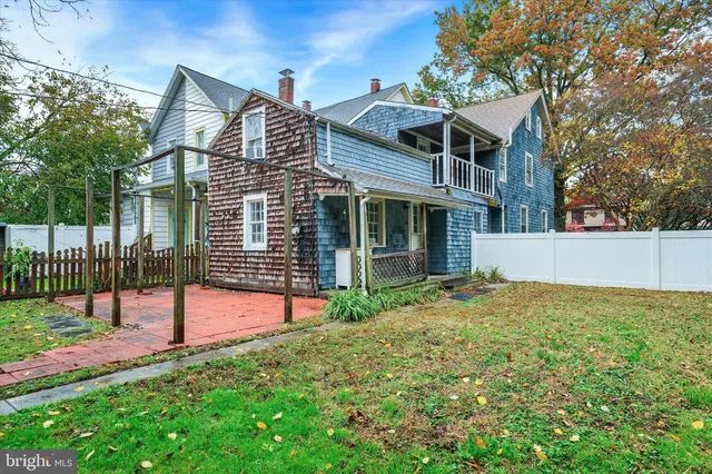 a view of a house with a yard and porch
