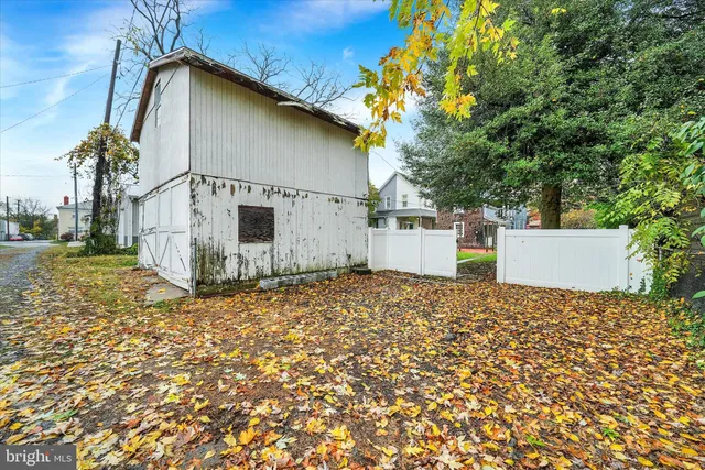 a backyard of a house with garage and parked
