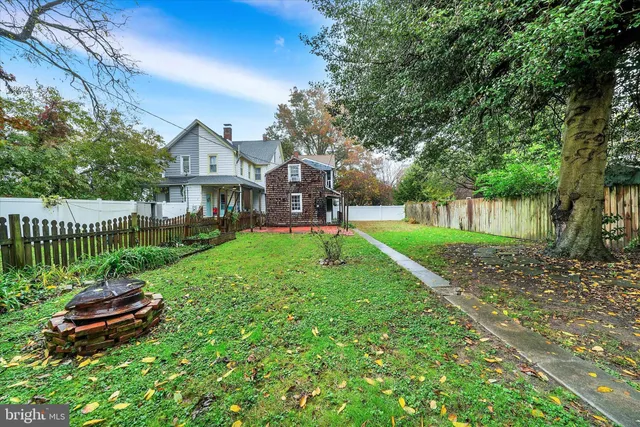 a view of a house with a yard and table in a yard