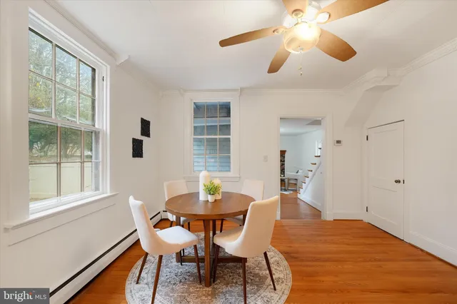 a dining room with furniture and window