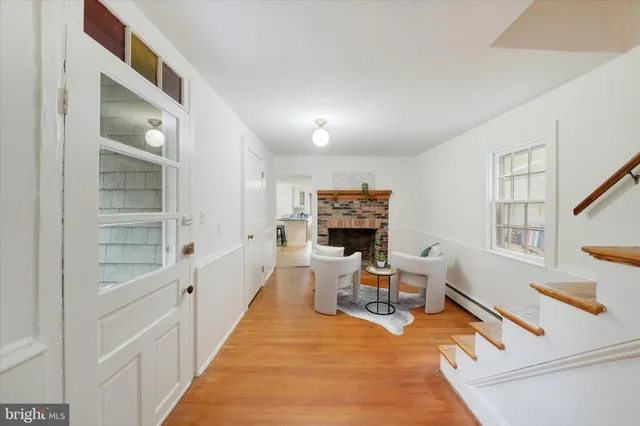a living room with furniture a flat screen tv and a large window