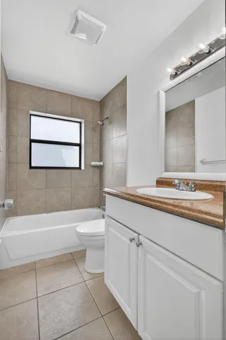 a bathroom with a sink a toilet a mirror and bathtub