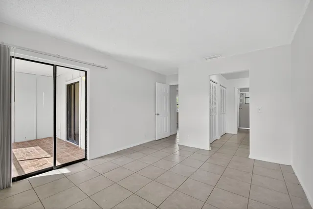 a view of an empty room with sliding glass door