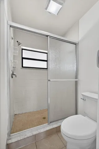 a bathroom with a glass shower door