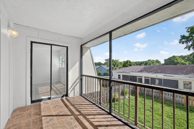 a view of a balcony with wooden floor