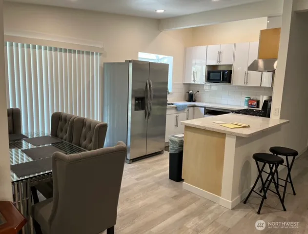 a work place with a couch and a refrigerator