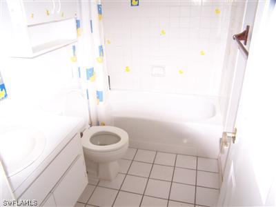 18349 Matanzas Road Fort Myers, FL 33967 - Photo 6 of 10 a bathroom with a granite countertop toilet and a sink