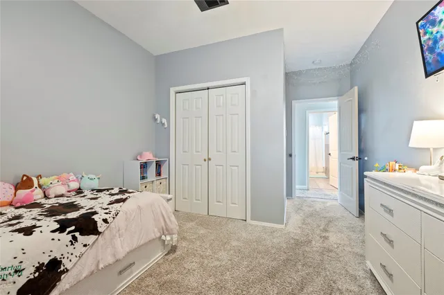 a bed room with a bed and a painting on the wall