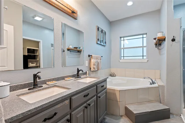 a white bath tub sitting next to a shower