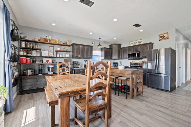 a kitchen with stainless steel appliances granite countertop a refrigerator stove microwave and sink