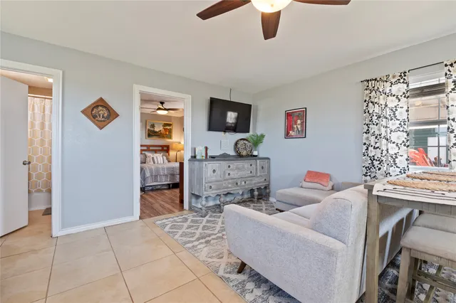 a living room with furniture and kitchen view