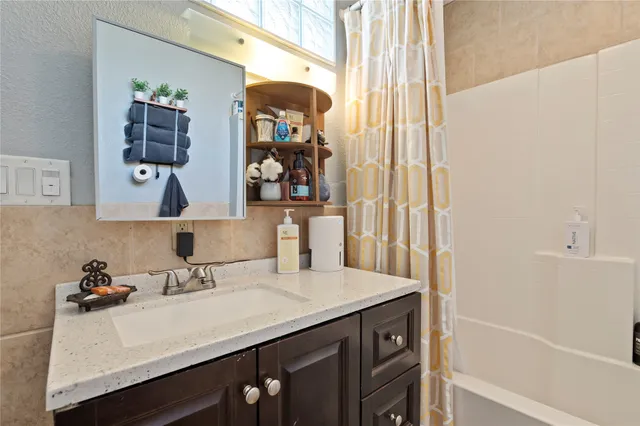 a bedroom with a bed and a flat tv screen on dresser