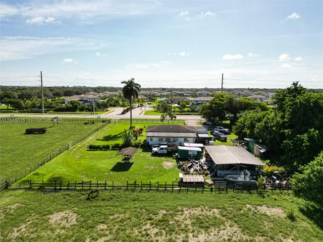 an aerial view of a house with a garden and lake view