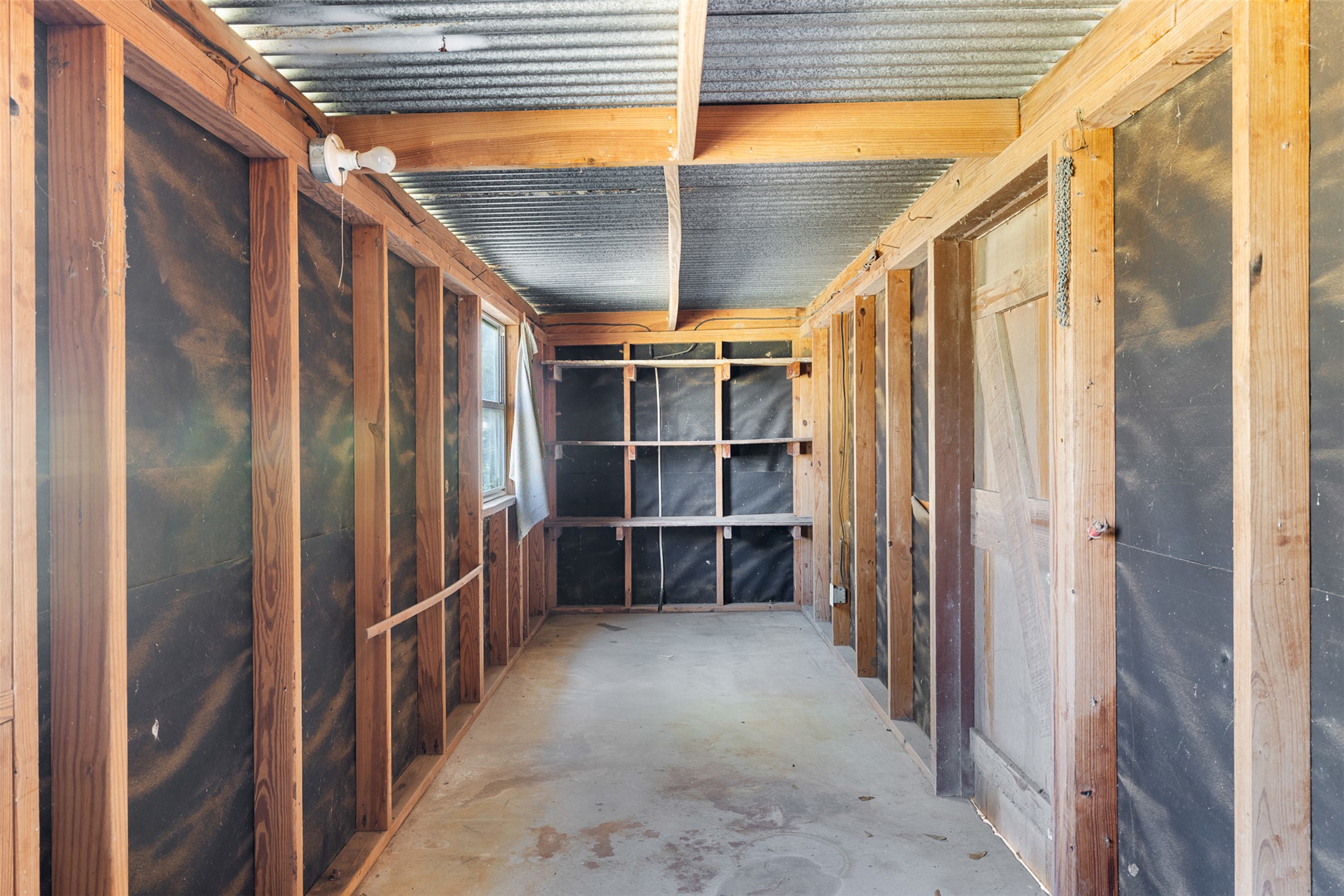809 Main Street Lexington, TX 78947 - Photo 22 of 23 a view of walk in closet with empty racks