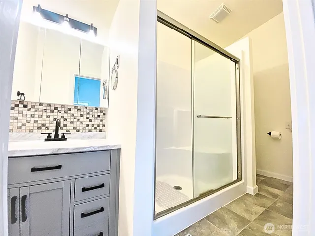 a view of room with a ceiling fan and a window