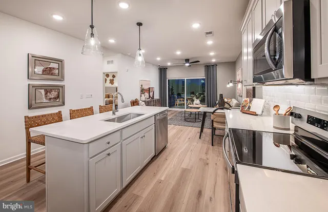 a kitchen with stainless steel appliances kitchen island granite countertop a sink and cabinets