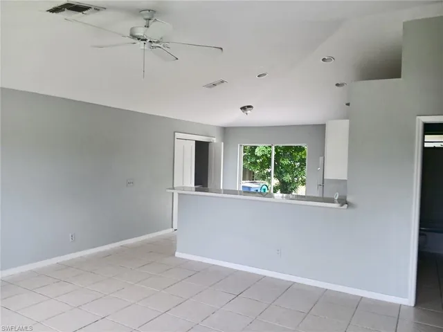 a view of room with window and a ceiling fan