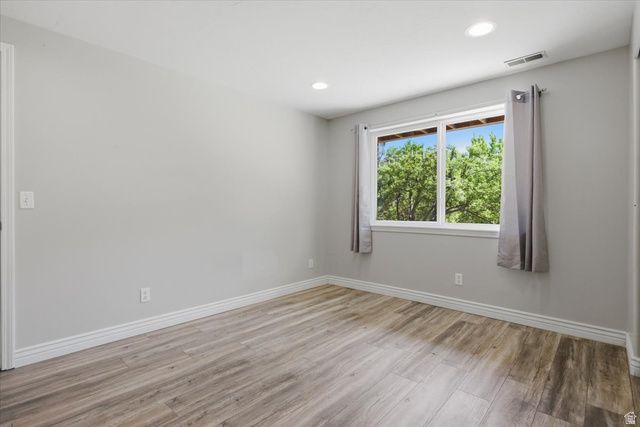 12317 Cypress Point Way Draper, UT 84020 - Photo 30 of 41 Hardwood-style flooring in a light wood-tone finish throughout a room featuring a large window with white trim