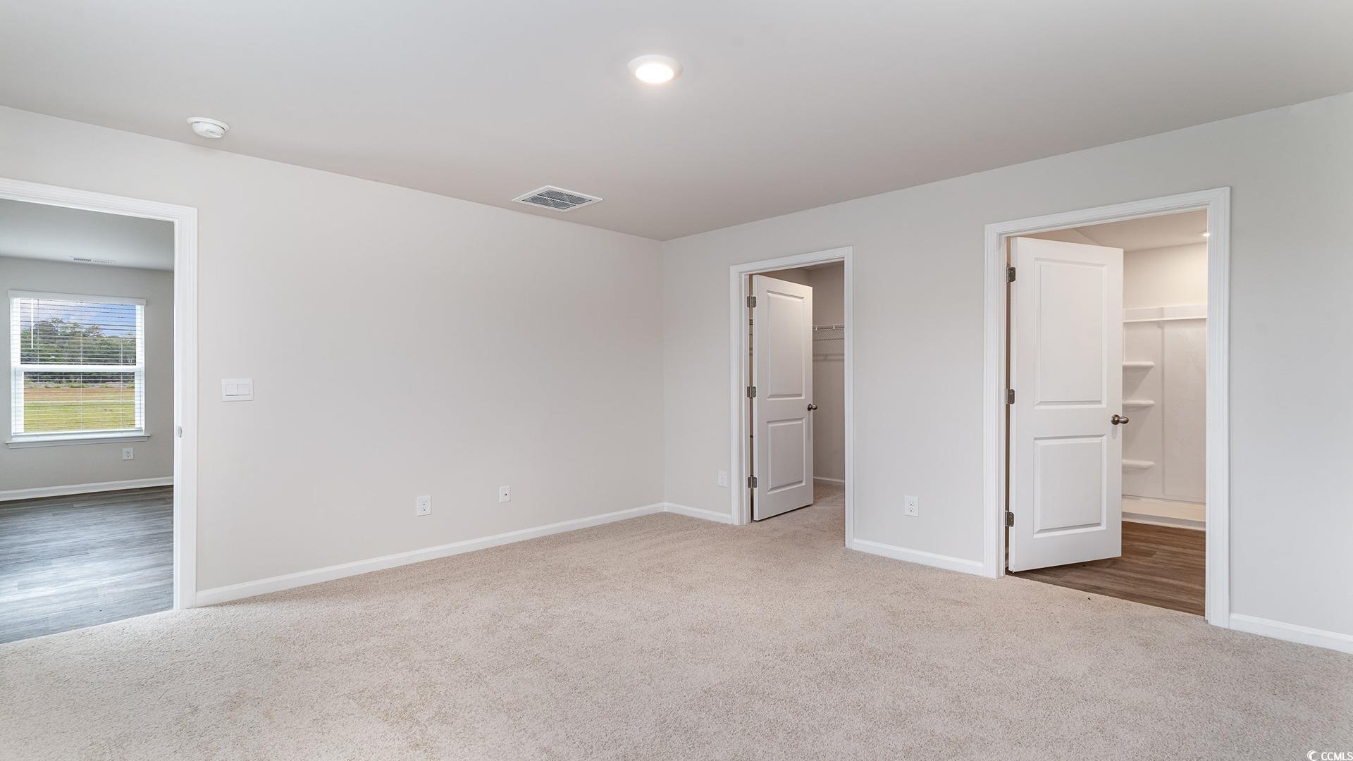 425 Flank Street Myrtle Beach, SC 29588 - Photo 8 of 19 Unfurnished bedroom with carpet floors, a walk in