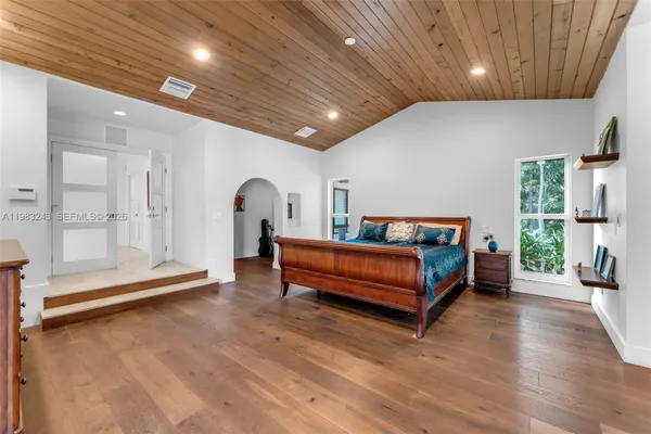 a view of a house and a yard with swimming pool in front of it
