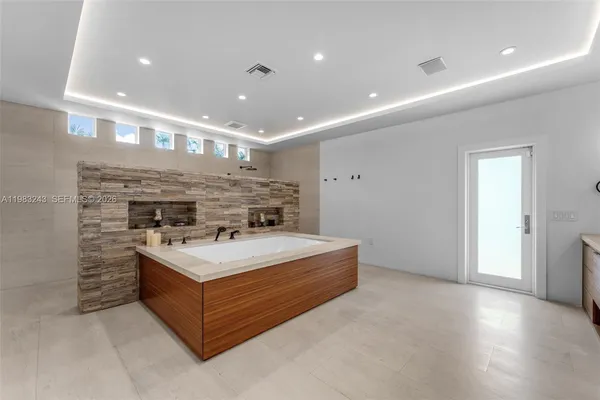 a kitchen with stainless steel appliances kitchen island granite countertop furniture and a large window
