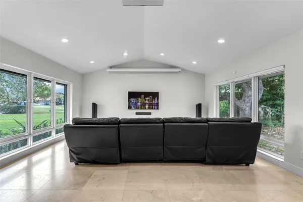 an aerial view of residential houses with outdoor space and ocean view