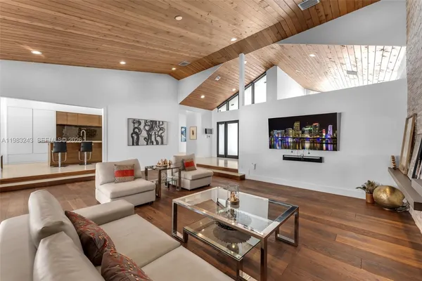 a view of a lobby with a couch and a potted plant