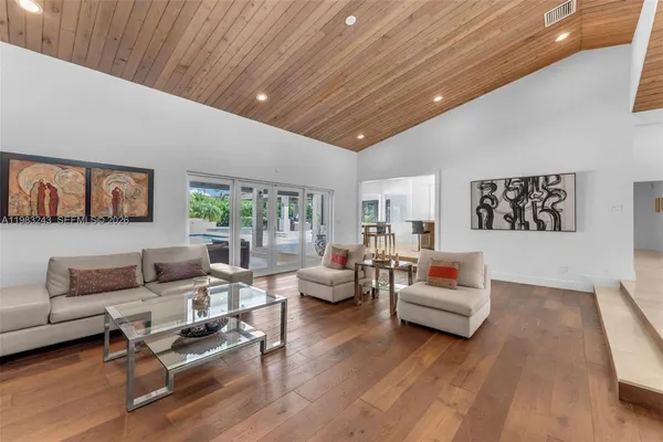 a view of a livingroom with furniture window and wooden floor