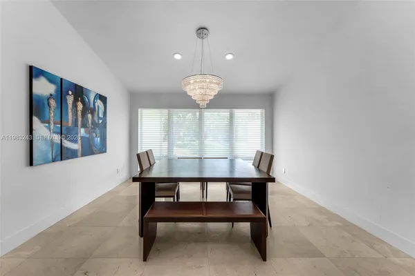 a kitchen with kitchen island cabinets and refrigerator
