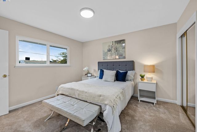 a bedroom with a bed and a table